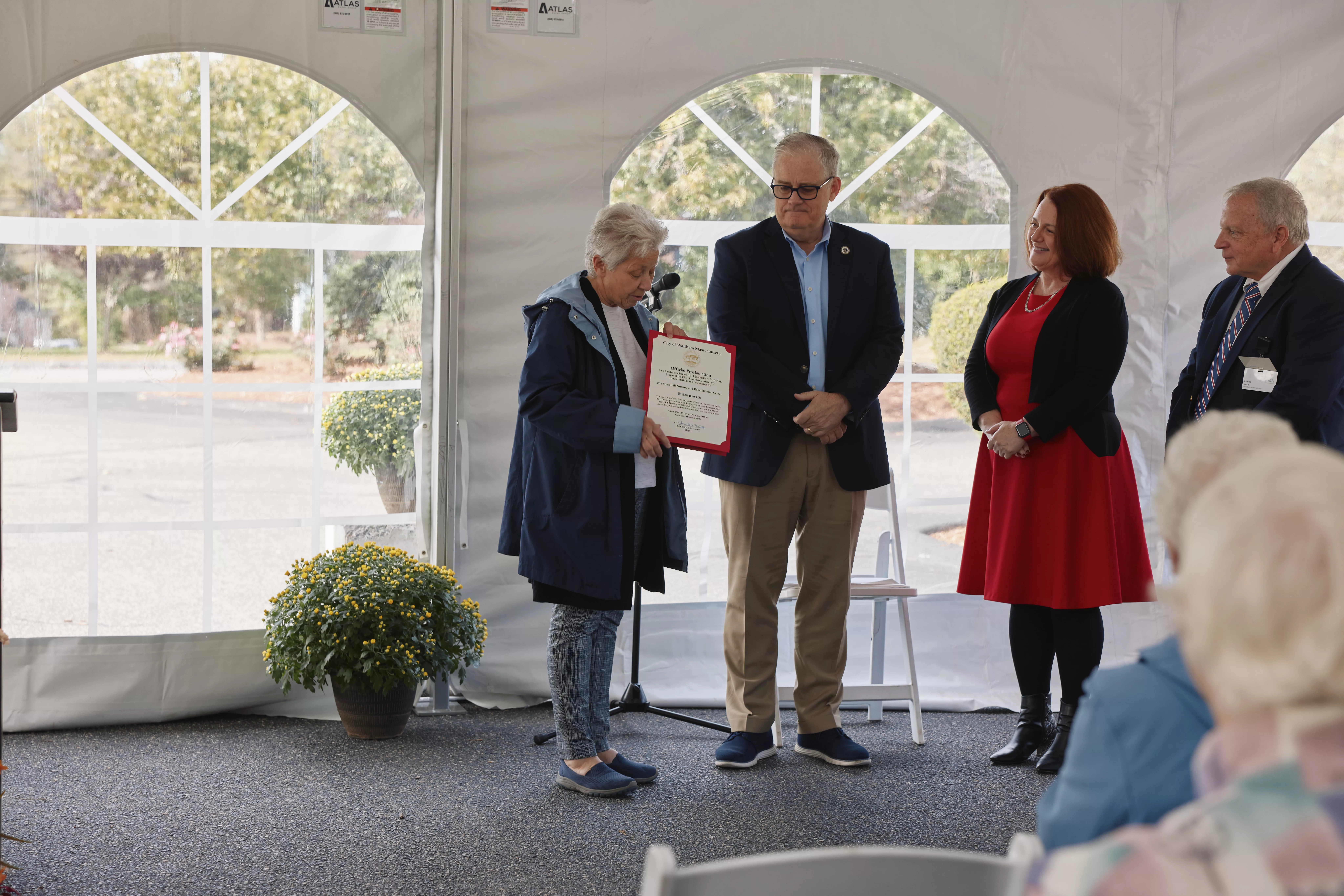 Watham Mayor Jeannette McCarthy presents MH President James Tracey with a proclamation Also pictured Rep Thomas Stanley and